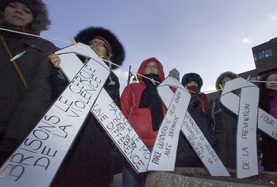 A group of women hold ribbons denouncing violence during a ceremony commemorating victims of the Montreal Massacre in Montreal, December 6, 2009. Today marks the twentieth anniversary of Canada's worst mass shooting when Mark Lepine entered the University of Montreal engineering school and in a shooting rampage killed fourteen women. REUTERS/Christinne Muschi (CANADA CONFLICT ANNIVERSARY)