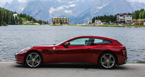 A red Ferrari GTC4Lusso, a low-slung car that looks something like a two-door station wagon.