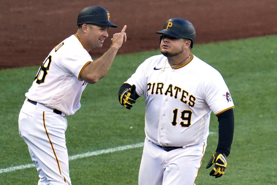 Pittsburgh Pirates' Daniel Vogelbach (19) is greeted by third base coach Mike Rabelo as he rounds third base after hitting a solo home run off San Francisco Giants relief pitcher Dominic Leone during the eighth inning of a baseball game in Pittsburgh, Saturday, June 18, 2022. The Giants won 7-5. (AP Photo/Gene J. Puskar)