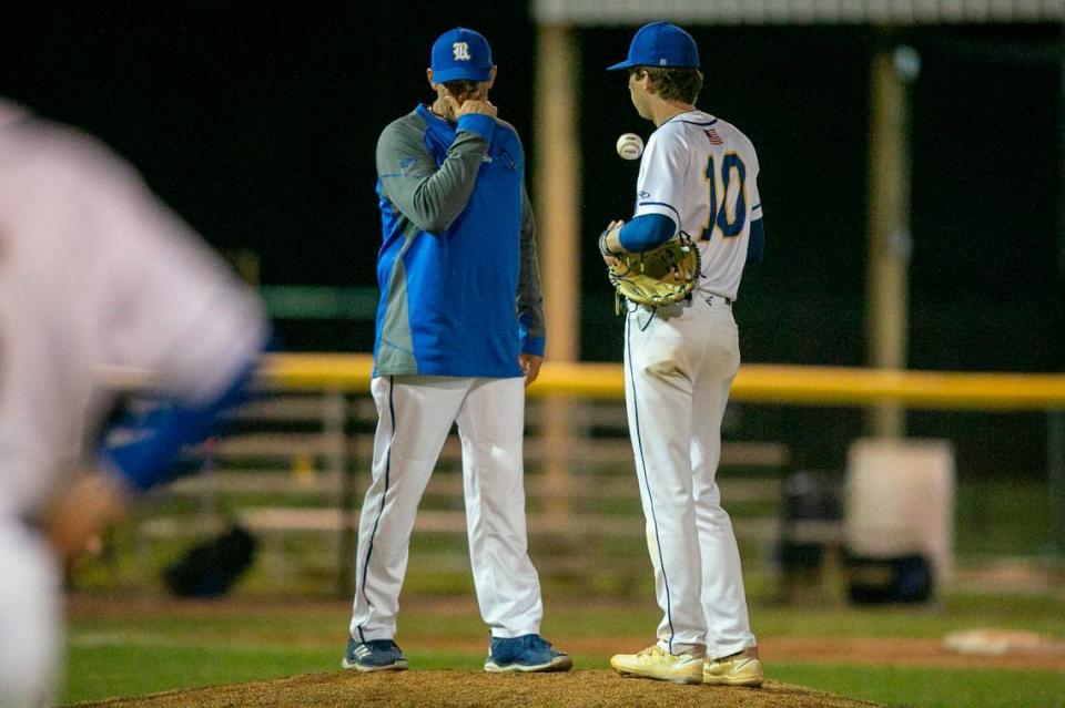 Resurrection pitcher Cole Tingle discusses with pitching coach Jon Reynolds on the mound during a game against Bayside Academy at MCC Park in Pascagoula on Thursday, March 10, 2022.
