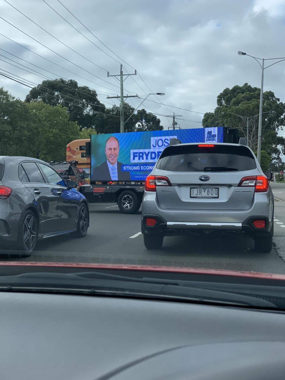 A billboard of Josh Frydenberg stopping Melbourne traffic.  Source: Reddit