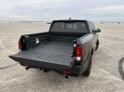 <p>While the Ridgeline's bed is useful, we found it a bit shallow compared to some of its competitors. Still, at 63 inches long it's plenty spacious for moving all sorts of stuff. Plus, there's a lockable, water-tight storage space underneath for tucking away more important items. </p><p>Even cooler is the dual-opening tailgate, which can flip down in the traditional fashion or open to the left side on a hinge. It's an incredibly useful bit of engineering for loading and unloading. </p>