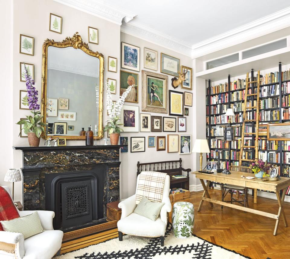 salon inspired living room with books and a gallery wall