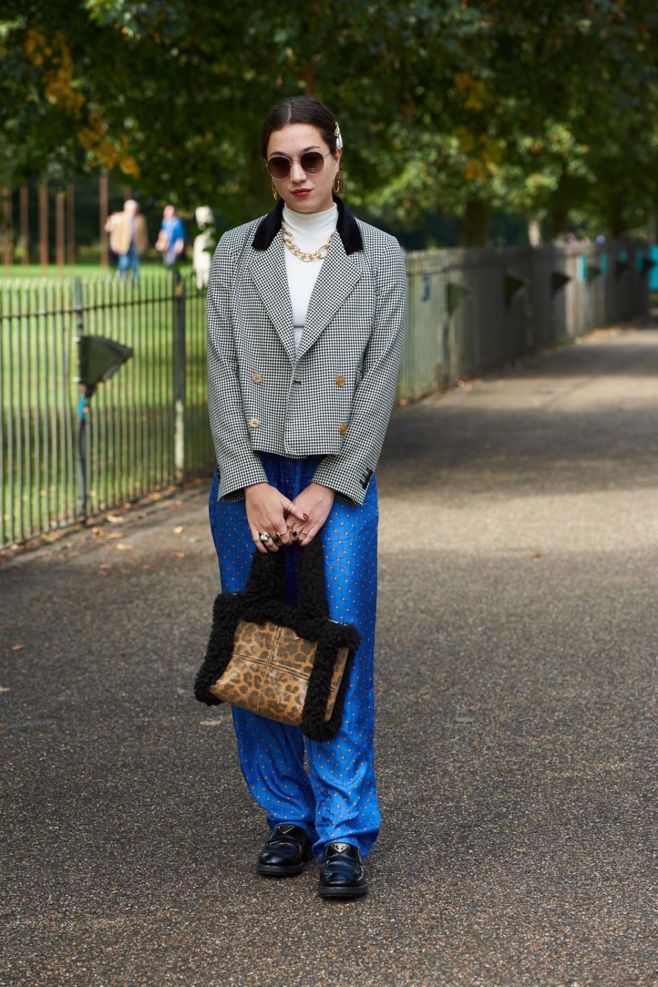 The handbag and the trousers were both rented from Hurr, pictured here at London Fashion Week. (Saira MacLeod/Shutterstock)