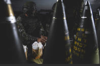 In this photo released by the Taiwan Military News Agency, a Taiwanese soldier prepares artillery rounds for a live firing drill to deter a coastal landing force during the Han Guang exercise held on the island of Penghu, Taiwan, Wednesday, Sept. 15, 2021. Taiwan's annual five-day Han Guang military exercise is designed to prepare the island's forces for an attack by China, which claims Taiwan as part of its own territory. (Military News Agency via AP)