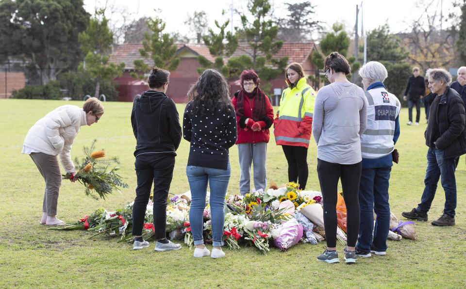 Mourners pay their respects to Eurydice Dixon at the soccer field where her body was found. Source: EPA