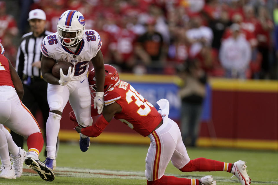 Buffalo Bills running back Devin Singletary (26) runs with the ball as Kansas City Chiefs cornerback Jaylen Watson defends during the first half of an NFL football game Sunday, Oct. 16, 2022, in Kansas City, Mo. (AP Photo/Charlie Riedel)