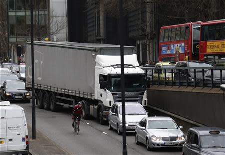 A cyclist passes traffic during London Underground strikes in central London February 6, 2014. REUTERS/Olivia Harris