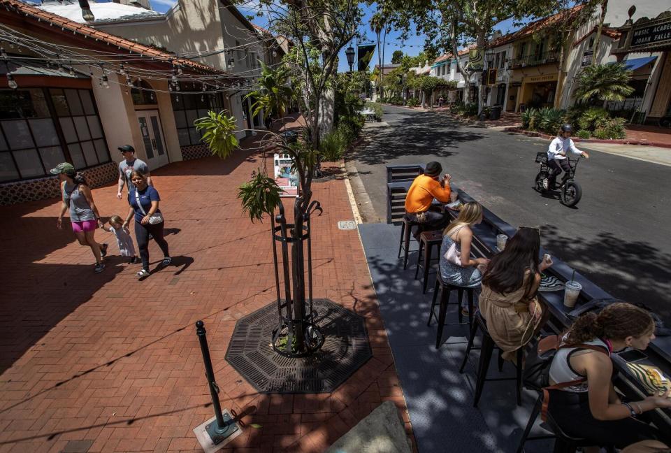 People gather on State Street in Santa Barbara.