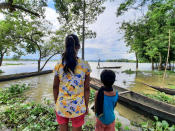 Two girls of Laibil village in Sibsagar district watches increase level of the water due to heavy rain in Sibsagar district of Assam, India, on July 22, 2020. .Many villages have been affected due to flood more than 500 families have been affected till July according to the report. (Photo by Dimpy Gogoi/NurPhoto via Getty Images)