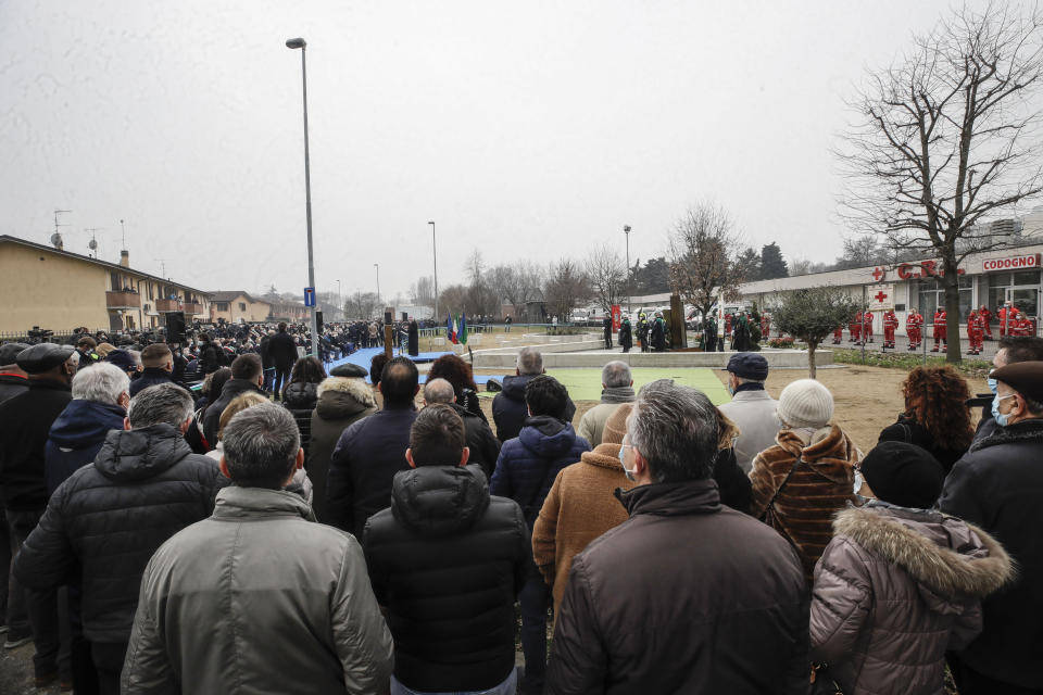 Codogno's citizens attend the unveiling of a memorial for Covid deaths, in Codogno, northern Italy, Sunday, Feb. 21, 2021. The first case of locally spread COVID-19 in Europe was found in the small town of Codogno, Italy one year ago on February 21st, 2020. The next day the area became a red zone, locked down and cutoff from the rest of Italy with soldiers standing at roadblocks keeping anyone from entering of leaving. (AP Photo/Luca Bruno)