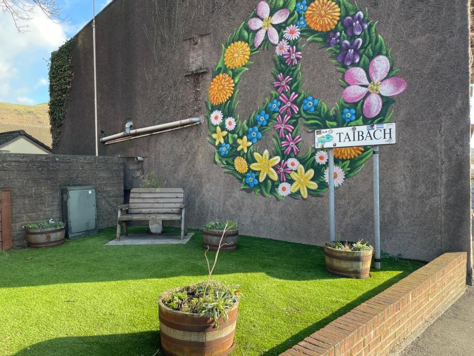 A community garden has been created on the road next to the entrance to Taibach, which sits in the shadow of the steelworks (The Independent)