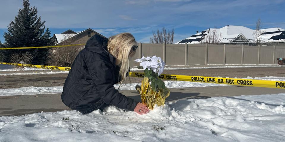 Sharon Huntsman, a member of The Church of Jesus Christ of Latter-day Saints from Cedar City, Utah, leaves flowers outside a home where eight family members were found dead in Enoch, Utah, Thursday, Jan. 5, 2023.