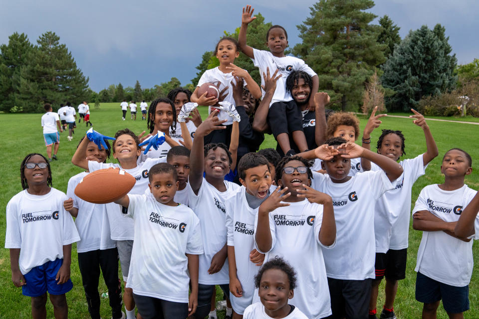 Shedeur Sanders poses with kids at Fred Thomas Park in Denver as part of Gatorade’s Equity in Sports event, which gave equipment to the N.E.D Falcons football and cheerleading programs.