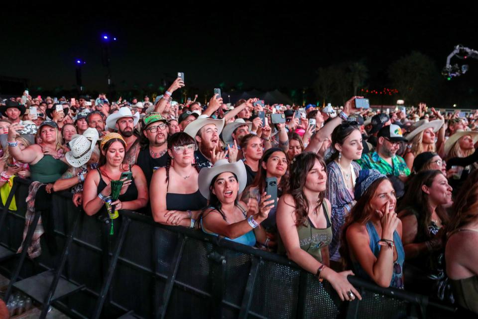 Festivalgoers listen to Post Malone perform a special set of country covers on the Mane Stage during Stagecoach in Indio, Calif., on Saturday, April 27, 2024.