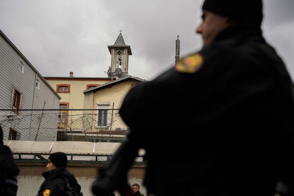 Turkish police officers stand guard in a cordoned off area outside the Santa Maria church, in Istanbul, Turkey, Sunday, Jan. 28, 2024. Two masked assailants attacked a church in Istanbul during Sunday services, killing one person, Turkish officials said. (AP Photo/Emrah Gurel)