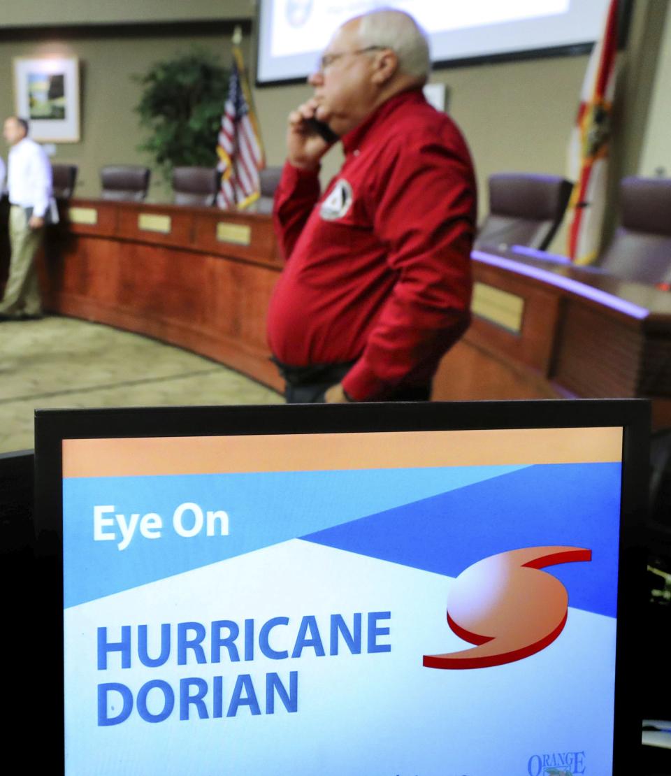 Keith Kotch, acting Manager of the Orange County Office of Emergency Management, talks on his phone before a press conference on the status of Hurricane Dorian at the Orange County Administration building in Orlando, Fla. (Joe Burbank/Orlando Sentinel via AP)