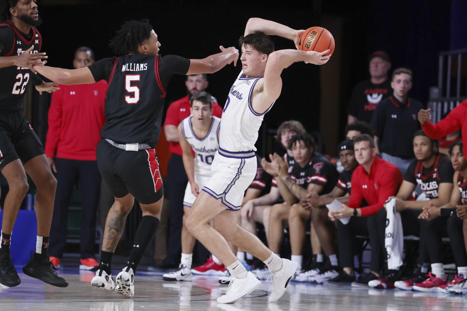 In a photo provided by Bahamas Visual Services, Northern Iowa's Nate Heise looks to pass the ball closely guarded by Texas Tech's Darrion Williams during an an NCAA college basketball game in the Battle 4 Atlantis at Paradise Island, Bahamas, Thursday, Nov. 23, 2023. (Tim Aylen/Bahamas Visual Services via AP)