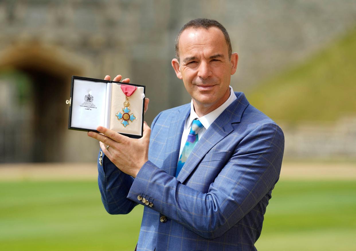 Martin Lewis, founder of the MoneySavingExpert.com website, poses with his medal after he was appointed a Commander of the Order of the British Empire (CBE) for services to broadcasting and consumer rights, following an investiture ceremony at Windsor Castle in Windsor, west of London on July 12, 2022. (Photo by Andrew Matthews / POOL / AFP) (Photo by ANDREW MATTHEWS/POOL/AFP via Getty Images)