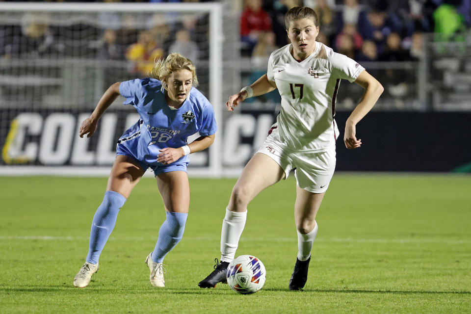 Florida State's Emma Bissell (17) looks to pass the ball as North Carolina's Maggie Pierce (28) defends during the first half of an NCAA women's soccer tournament semifinal in Cary, N.C., Friday, Dec. 2, 2022. (AP Photo/Karl B DeBlaker)