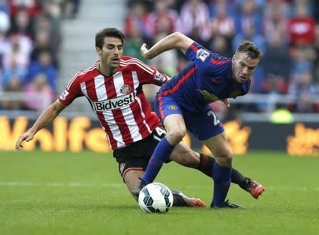 Manchester United's Tom Cleverley (R) challenges Sunderland's Jordi Gomez during their English Premier League soccer match at the Stadium of Light in Sunderland, northern England August 24, 2014. REUTERS/Andrew Yates