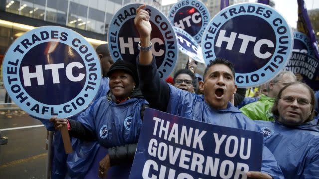 Participants cheer at a home care and healthcare workers rally in support of a $15 minimum wage, Tuesday, Nov. 10, 2015, in New York. New York Gov. Andrew Cuomo is raising the minimum wage for about 10,000 state workers to $15 an hour over the next six years.