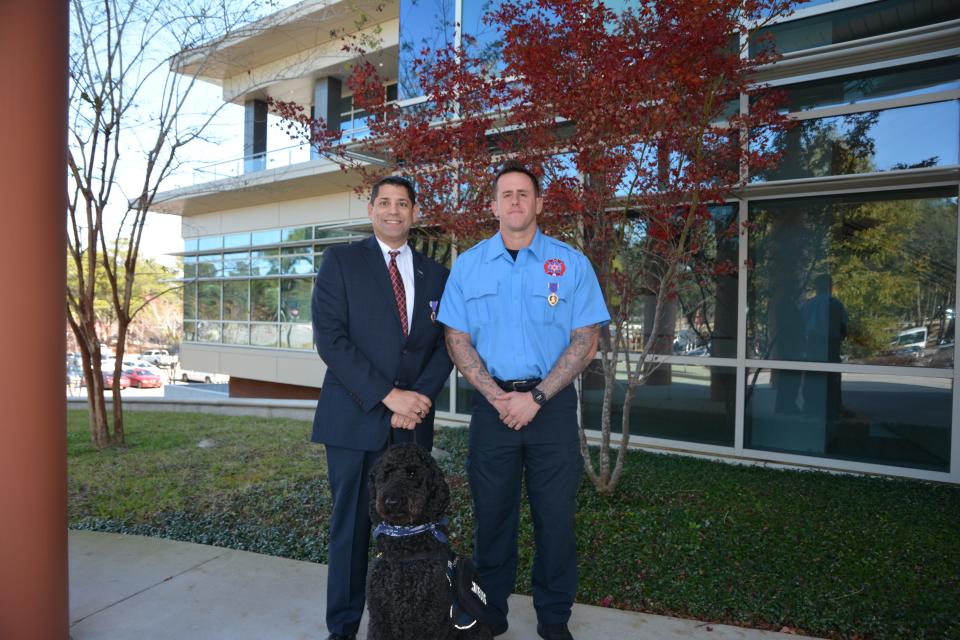 Purple Heart recipient, Jack Capra with his service dog, 7-year-old Labradoodle Rocco and Purple Heart recipient Erick Torres.