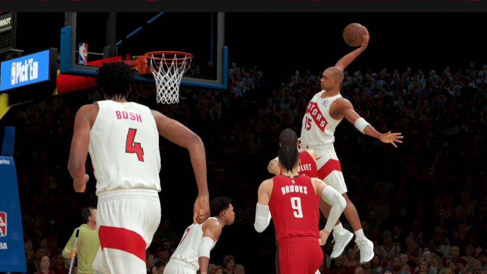 Screenshot from NBA 2K25 Arcade Edition. Recreation of a vintage game with Vince Carter (Raptors era) rising up for a slam as Chris Bosh runs along the left wing.