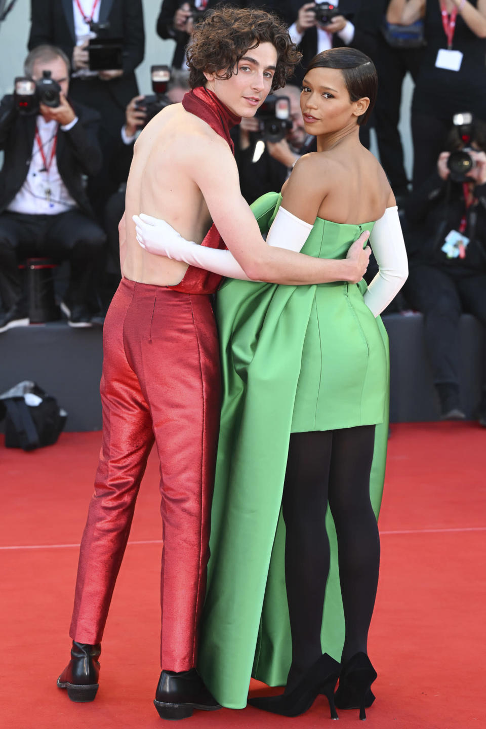 <p>Stop and go! Timothée Chalamet and Taylor Russell have fun with fashion at the <em>Bones & All </em>premiere at the Venice International Film Festival in Italy on Sept. 2. </p>