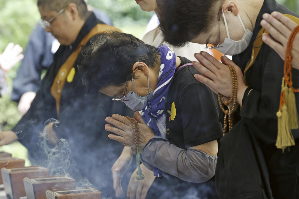 People offer prayers to the war dead, at the Chidorigafuchi National Cemetery, where the remains of unknown victims of World War II are honored, in Tokyo, Japan, Tuesday, Aug. 15, 2023. Japan holds annual memorial service for the war dead as the country marks the 78th anniversary of its defeat in the World War II. (Kyodo News via AP)