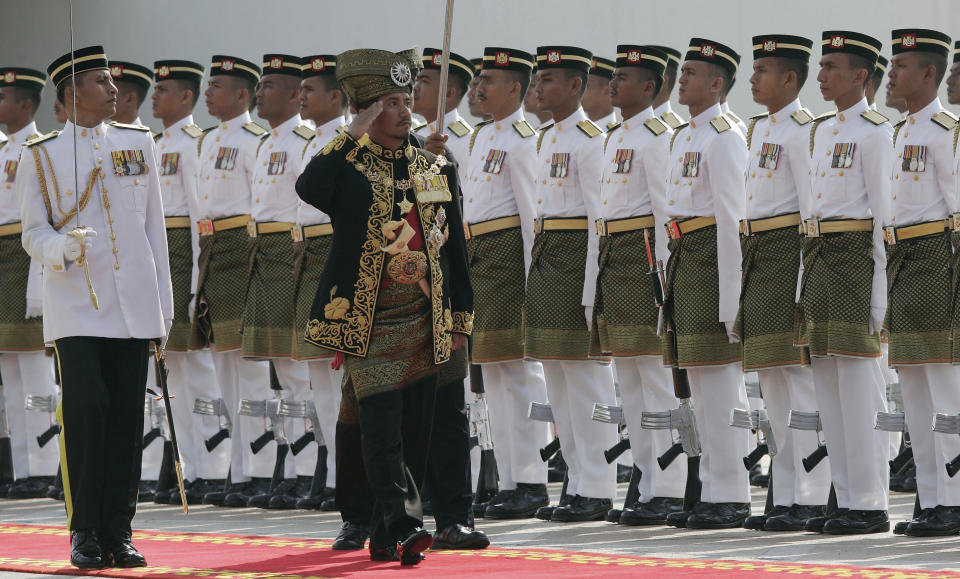 FILE - In this Feb. 16, 2009, file photo, then Malaysia's King Sultan Mizan Zainal Abidin, center, inspects the guard of honor during the opening of the parliament in Kuala Lumpur, Malaysia. King Sultan Muhammad V shocked the nation by announcing his abdication in January 2019, days after returning from two months of medical leave. The 49-year-old sultan from eastern Kelantan state only reigned for two years as Malaysia's 15th king and didn't give any reason for quitting. (AP Photo/Lai Seng Sin, File)