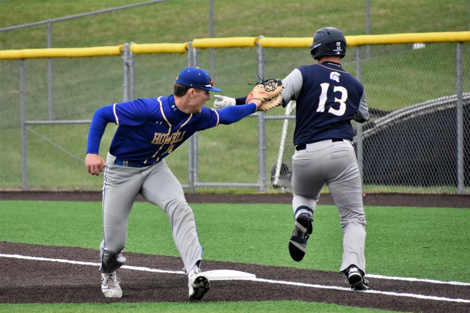 Francis Howell's Brett Norfleet ties to apply a tag on Battle's Seth Wray during the Vikings' 11-0 win over the Spartans on April 15, 2022, at Battle High School.