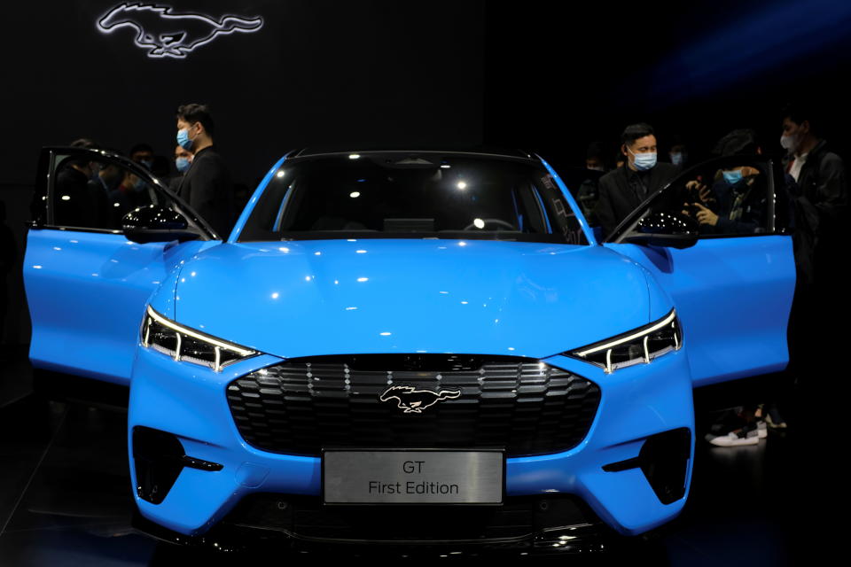 Visitors check on a Ford Mustang Mach-E electric vehicle displayed at a launch event in Shanghai, China April 13, 2021. REUTERS/Yilei Sun