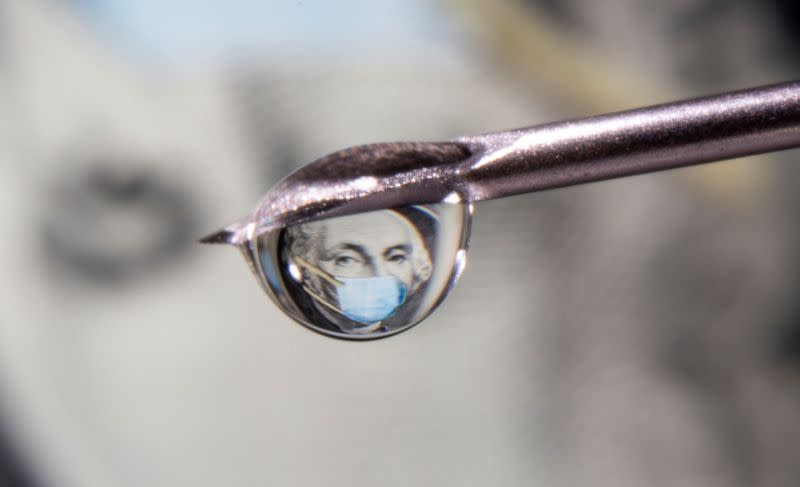 FILE PHOTO: George Washington is seen with a printed medical mask on a one dollar bill reflected in a drop on a syringe needle in this illustration