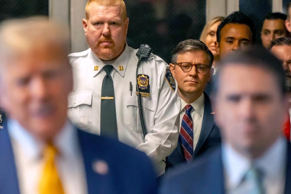US Speaker of the House Mike Johnson (R-LA) listens as former U.S. President Donald Trump speaks to the media as he arrives with attorney Todd Blanche (R) to court during his trial for allegedly covering up hush money payments (Getty Images)