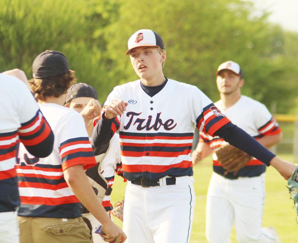 Pontiac sophomore Henry Brummel gets congratulated after retiring Tremont in the sixth inning of Monday's regional final at Olympia. Brummel struck out nine in pitching the Tribe to a regional title, 9-1, its first since 2016.