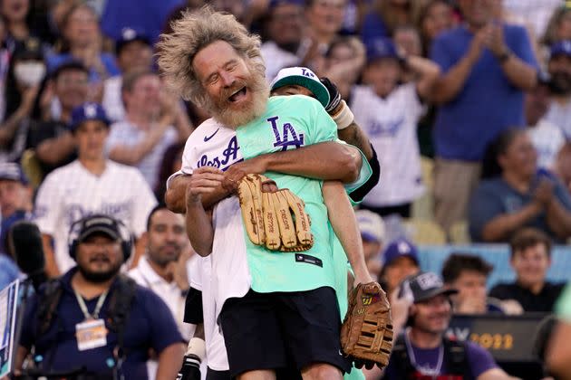 Actor Bryan Cranston is lifted by former Los Angeles Dodgers player Andre Ethier during the MLB All Star Celebrity Softball game, Saturday, July 16, 2022, in Los Angeles. (AP Photo/Mark J. Terrill) (Photo: via Associated Press)