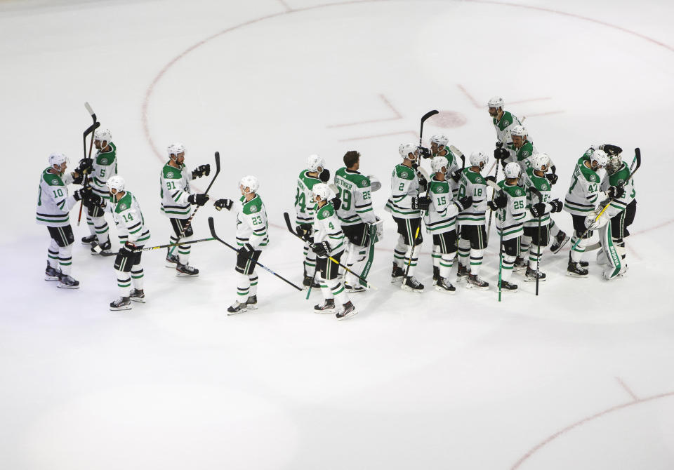 The Dallas Stars celebrate the win over the Calgary Flames after an NHL Western Conference Stanley Cup playoff hockey game, Thursday, Aug. 20, 2020, in Edmonton, Alberta. (Jason Franson/The Canadian Press via AP)