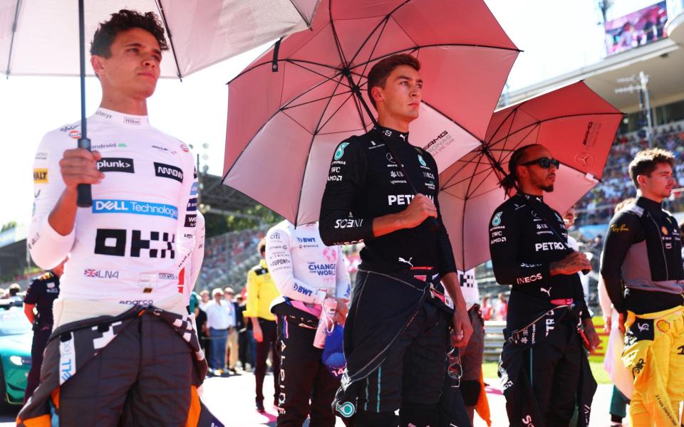 Lando Norris of Great Britain and McLaren, George Russell of Great Britain and Mercedes, Lewis Hamilton of Great Britain and Mercedes and the rest of the field stand for a minutes silence in tribute to Her Majesty Queen Elizabeth II, who died at Balmoral Castle on September 8, 2022, during the F1 Grand Prix of Italy at Autodromo Nazionale Monza on September 11, 2022 in Monza, Italy. - Getty Images