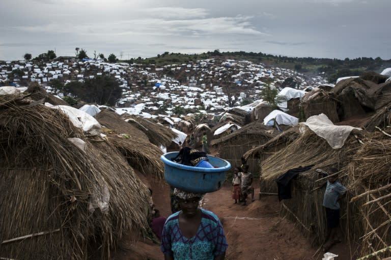 A Congolese woman walks through a camp for Internally Displaced Persons on March 20, 2018 in Kalemie, Democratic Republic of Congo