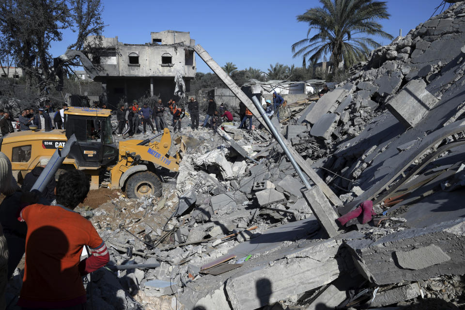 Palestinians search for survivors after an Israeli airstrike on building of Rayan family in Nusseirat refugee camp, central Gaza Strip, Thursday, Feb. 15, 2024. (AP Photo/Adel Hana)