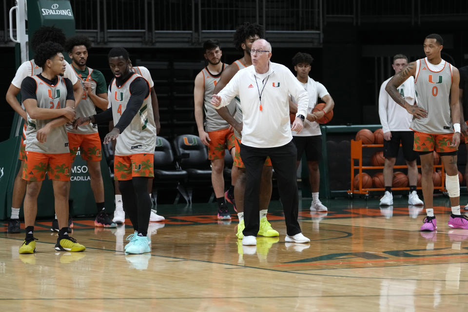 Miami head coach Jim Larranaga, center, works with players during practice at media day for the Miami NCAA college basketball team, Monday, Oct. 23, 2023, in Coral Gables, Fla. (AP Photo/Lynne Sladky)