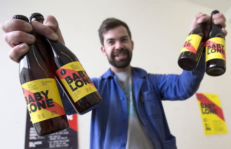 Sebastien Morvan, one of the founders of microbrewery Brussels Beer Project, displays bottles of beer called Babylone in his office in central Brussels, April 14, 2015. REUTERS/Yves Herman