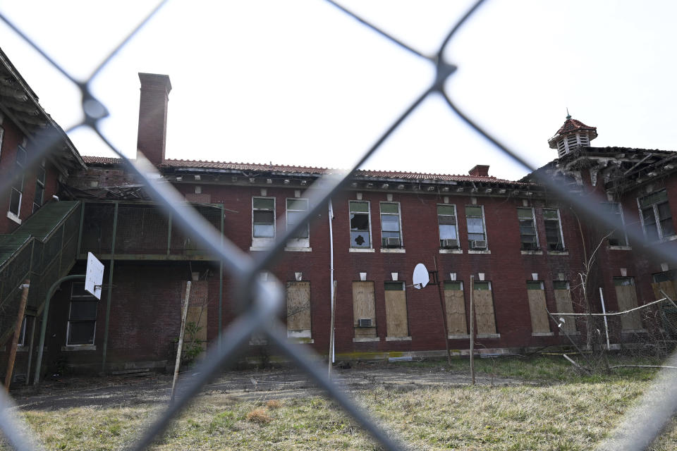 A basketball hoop is seen in a fenced off abandon building on the campus of St. Elizabeth near the Entertainment and Sports Arena, Friday, March 1, 2024, in Washington. The proposed move of the Capitals and Wizards sports teams to nearby Virginia has stoked concern in a pair of fragile Washington neighborhoods. (AP Photo/Terrance Williams)