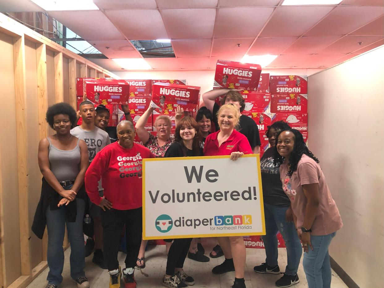 A group of volunteers is shown after helping unload more than 180,000 diapers donated by Huggies to the Diaper Fund of Northeast Florida. Grants made by supporters of The Community Foundation of Northeast Florida helped cover the cost of shipping to make the donation possible.