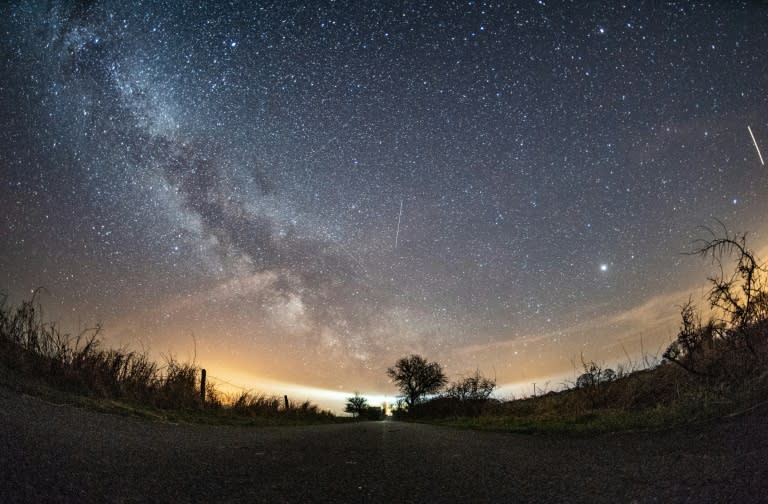 The milky way and meteors of the April Lyrids annual meteor shower in the night sky over the Baltic Sea