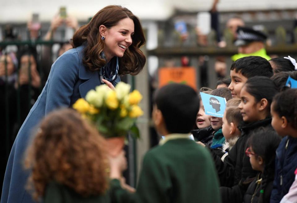 Kate was handed flowers by school pupils (Reuters)