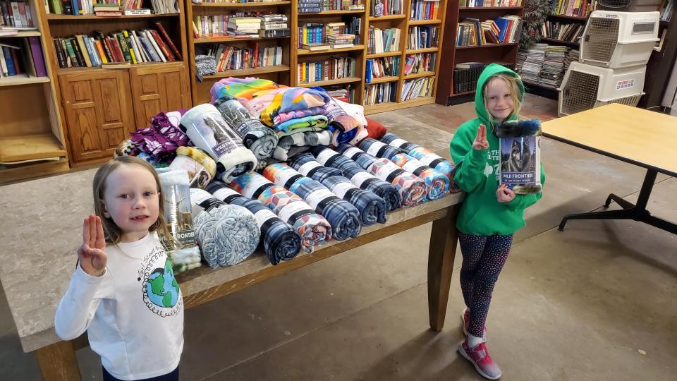 Members of Girl Scouts of the Texas and Oklahoma Panhandle Troop 5107 deliver blanket donations from the Share the Warmth Blanket Drive to the Code Blue Warming Station inside the Amarillo Housing First facility located at 207 N. Tyler St.