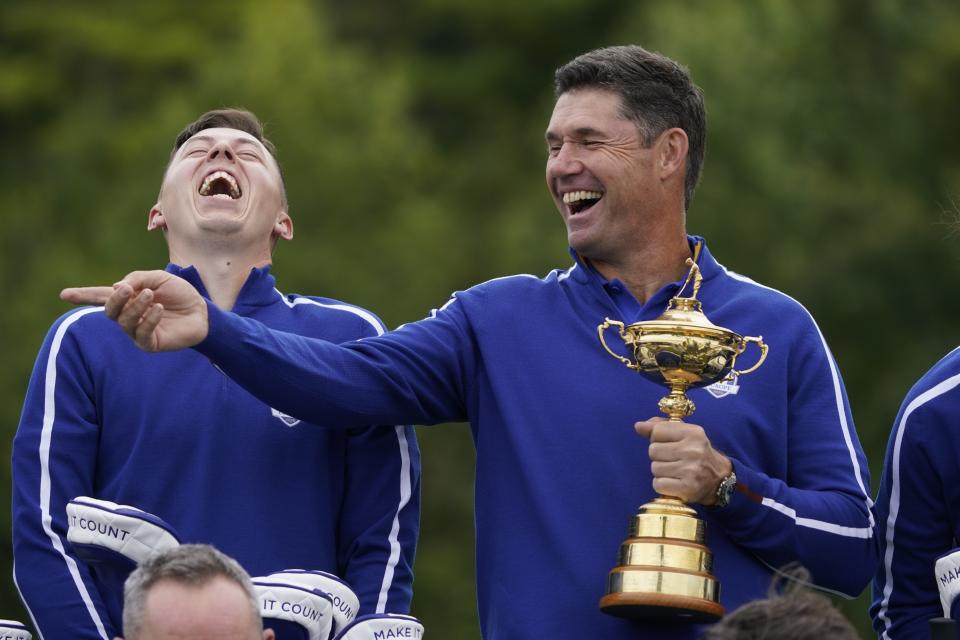 Team Europe captain Padraig Harrington and Team Europe's Matt Fitzpatrick smile as they pose for a team picture during a practice day at the Ryder Cup at the Whistling Straits Golf Course Tuesday, Sept. 21, 2021, in Sheboygan, Wis. (AP Photo/Charlie Neibergall)