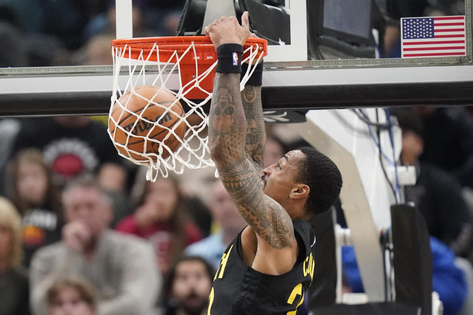 Utah Jazz forward John Collins (20) dunks against the Dallas Mavericks during the first half of an NBA basketball game, Monday, Jan. 1, 2024, in Salt Lake City. (AP Photo/Rick Bowmer)